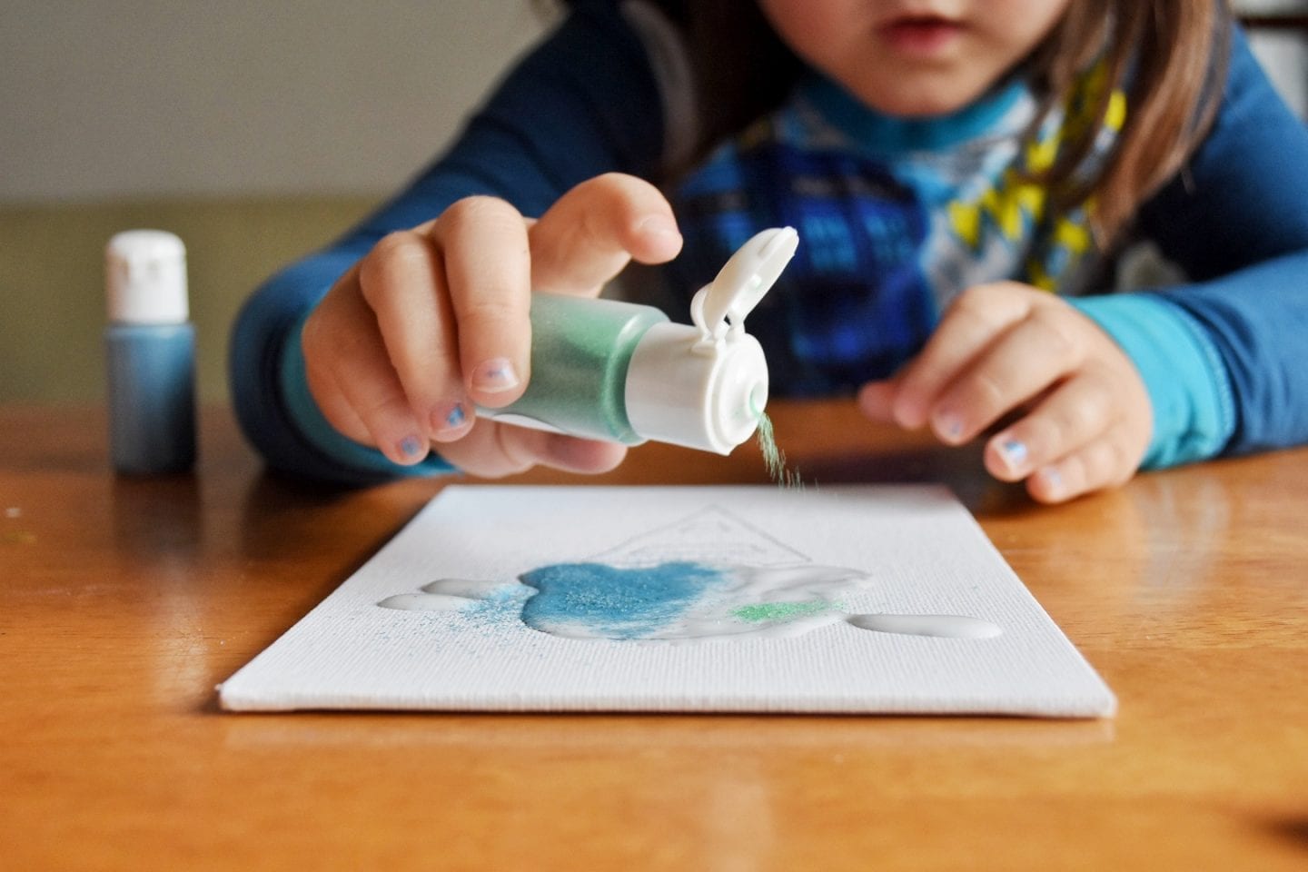 Child making sand art