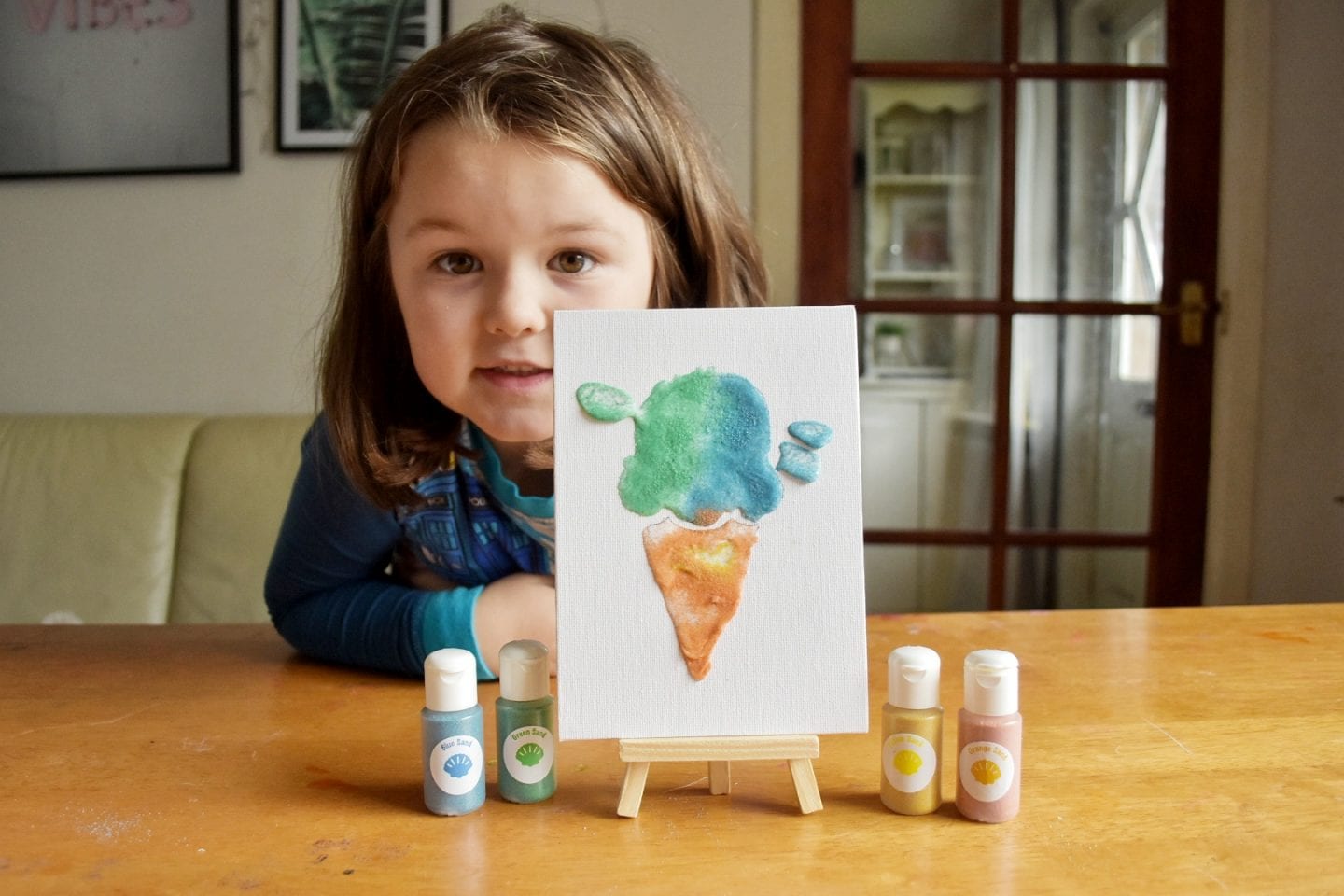 Child making sand art