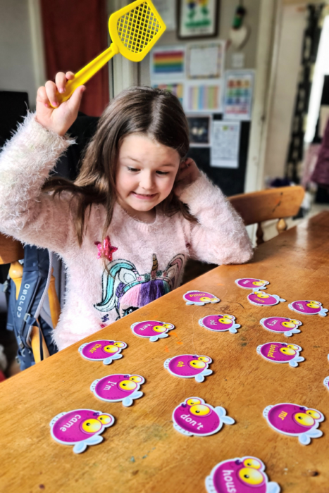 Happy girl playing educational game